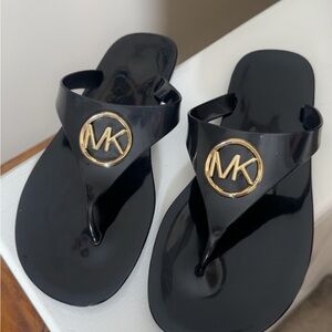 Michael Kors Glossy Black Flip Flops with Gold Emblem